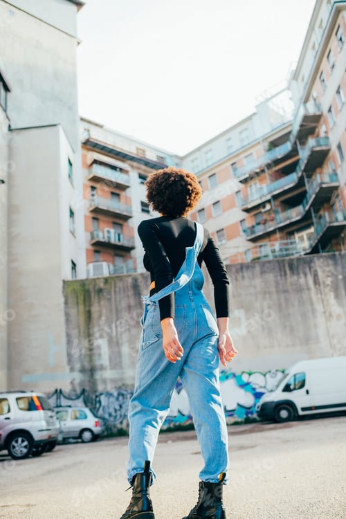 Preview: Back view young curly black afro hair woman walking away dancing spinning