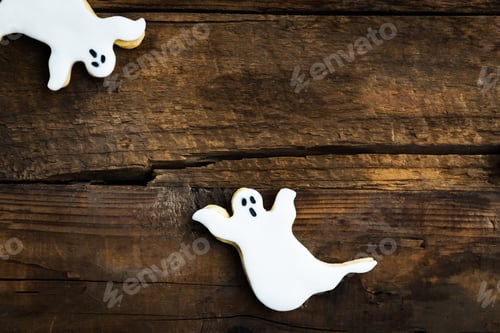 Preview: Ghost Shaped Halloween Cookies on Rustic Wooden Table