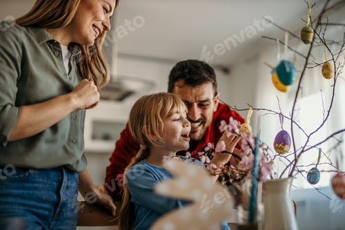 Preview: Family decorating easter tree at home for holiday celebration