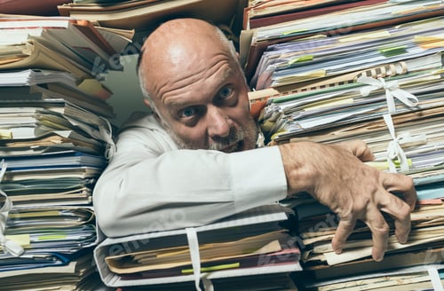 Preview: Panicked businessman overloaded with paperwork