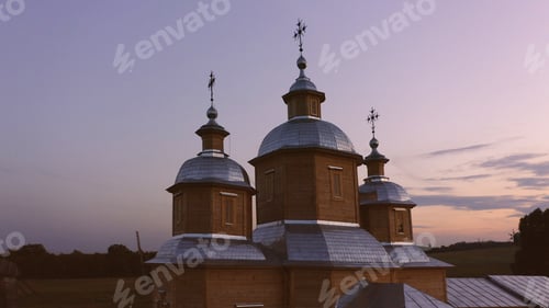 Preview: Wooden chapel with two three in the sunset.