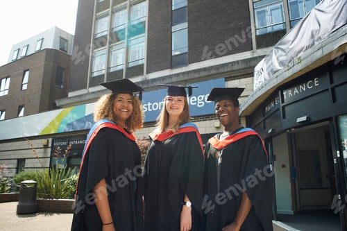 Preview: Portrait of three college students in graduation gowns and caps