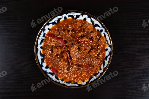 Preview: Asian food. Beef in spicy sauce with sesame seeds and chili pepper