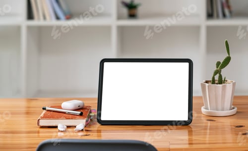 Preview: Blank screen portable tablet on table in office room. Mockup blank screen for product display.
