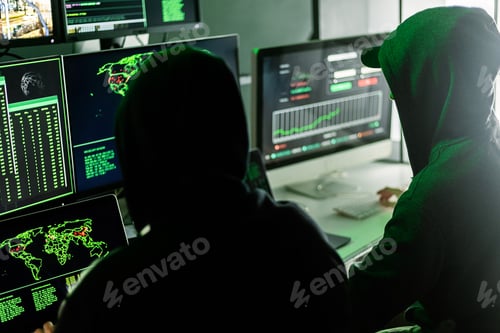 Preview: Hackers working on computers showing world maps and security camera footage