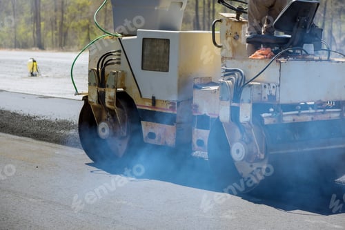 Preview: A worker uses an asphalt roller to lay asphalt on new road