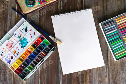 Preview: art painting, color pencils, brushes, watercolor paints, paper crayon pastel chalks wooden table
