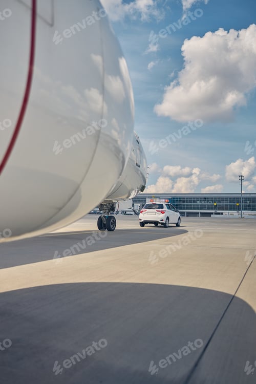 Preview: Follow-me car leading the newly arrived airliner