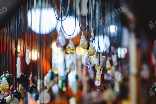 Preview: Quartz and other precious stones hung on necklaces in a mineral and beauty shop.
