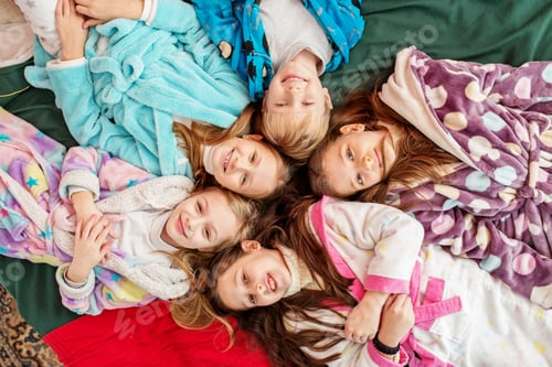 Preview: Group of children having fun at pajama party. Cozy home. Top view
