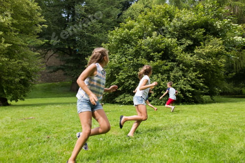 Preview: group of happy kids or friends playing outdoors