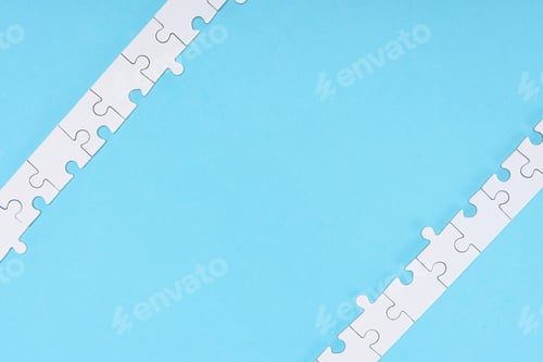 Preview: top view of white puzzle pieces arranged on blue backdrop