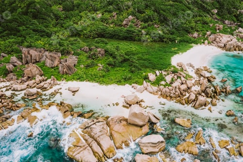 Preview: Aerial drone shot of Seychelles tropical remote secret beach Marron at La Digue island. White sand