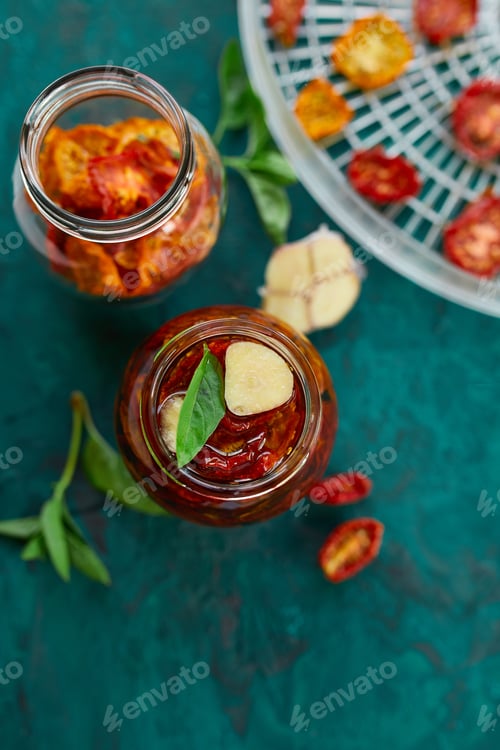 Preview: Homemade sun dried tomatoes with herbs, garlic in olive oil in a glass jar