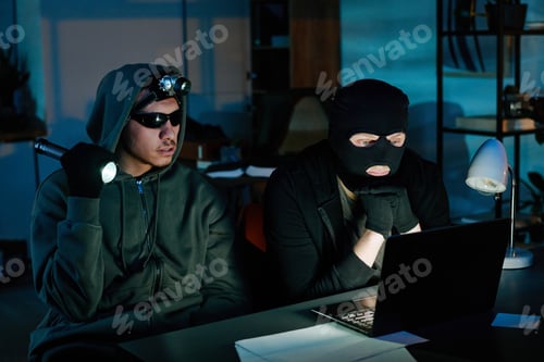 Preview: Two Young Adult Men Breaking into Office Computer during Nighttime Robbery