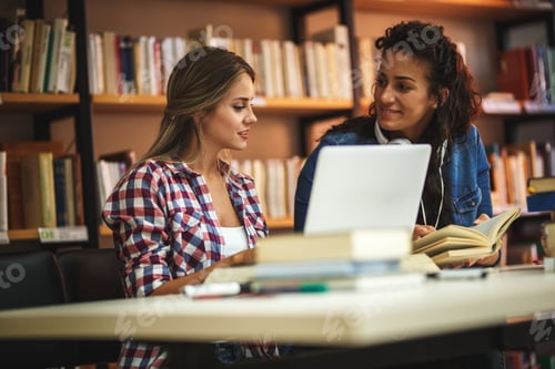Preview: Group of female students study in the college library.