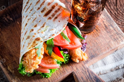 Preview: Tasty tortilla with vegetables and chicken on old wooden table