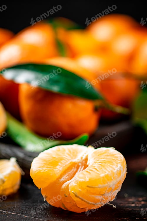 Preview: Peeled fresh tangerines. On a black background.