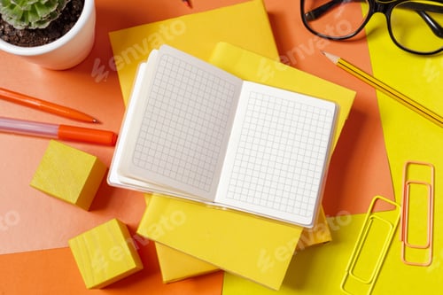 Preview: Notepad and office supplies on a colorful desk with plants and pens for study activities