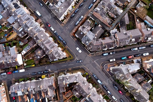 Preview: Aerial view directly above rooftops and road junction in a typical English suburban neghbourhood