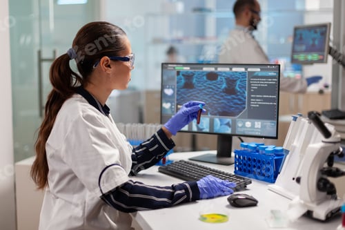 Preview: Medical researcher holding blood vaccutainer microbiology lab