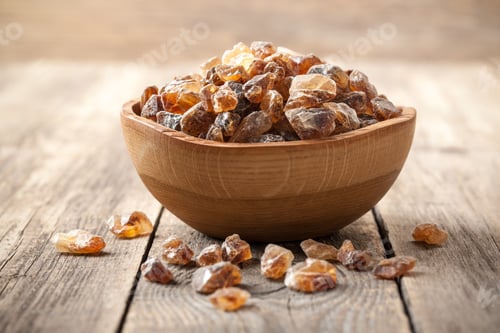 Preview: Brown sugar crystals in wooden bowl