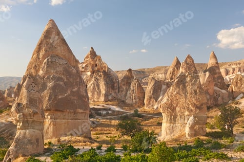 Preview: Beautiful shot of rock formations surrounded by mountains under a blue sky