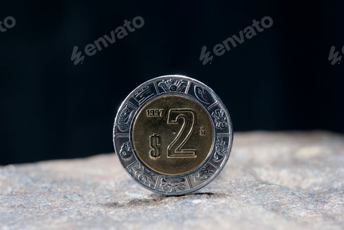 Preview: Closeup of a silver 1 Dollar 1994 Hong Kong on the rocky surface with a dark background