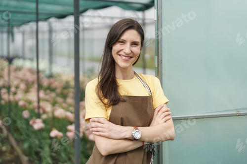 Preview: Smiling florist business woman portrait at the green house.