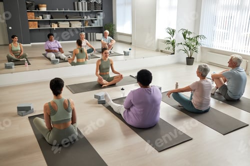 Preview: People exercising in yoga studio