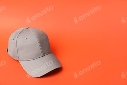 Preview: Beige baseball hat on orange background, space for text