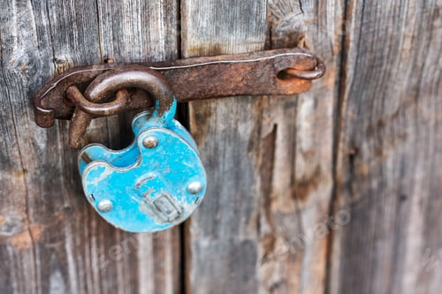 Preview: Blue old rusty unlocked padlock on wooden door