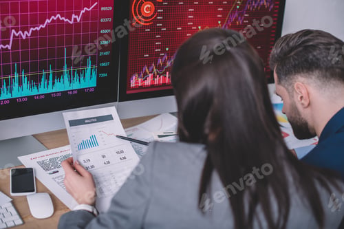 Preview: Selective focus of information security analysts planning work with charts on papers and computer