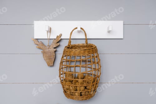 Preview: Wicker Basket with Brown Balls Hanging on Wall