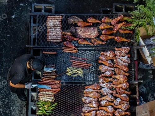 Preview: Chef prepares BBQ meat at a country fair. Shot from above in a flat-lay style