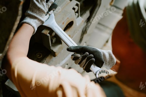 Preview: Unrecognizable Woman Repairing Vehicle Undercarriage