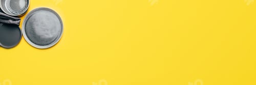 Preview: Gray empty ceramic plates on yellow
