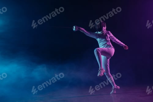 Preview: Fencer in fencing mask and suit training with rapier on black background with smoke and lighting