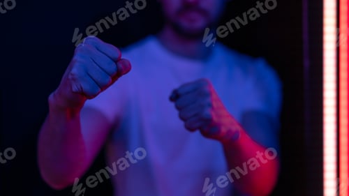 Preview: Close-up of clenched male fists before striking.