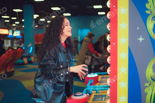 Preview: Woman enjoying arcade games at a lively indoor entertainment center