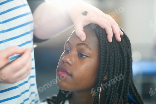 Preview: Woman applying make-up to young woman