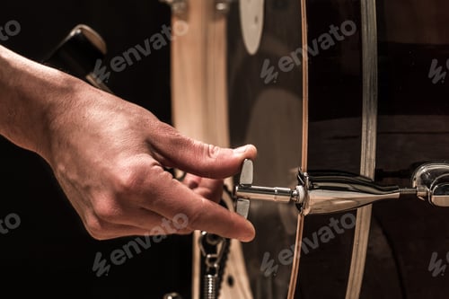 Preview: man adjusts percussion instruments, creative music concept