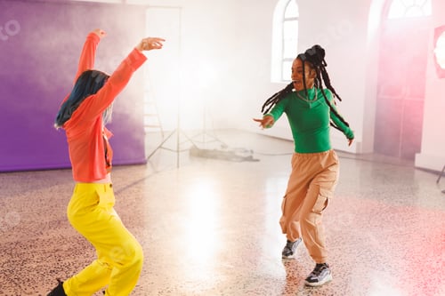 Preview: Image of group of two happy diverse female hip hop dancers in studio