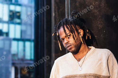 Preview: Stylish black man with dreadlocks in buns