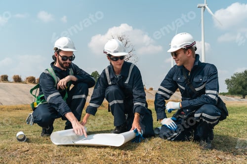 Preview: Wind turbine engineer team reviewing energy project blueprint for sustainability and clean energy
