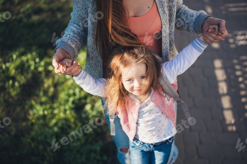 Preview: Little Girl Holding Hands With Someone Outdoors