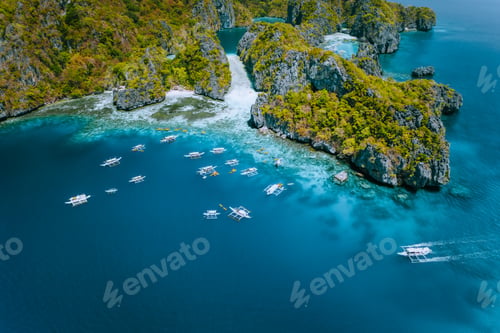 Preview: Aerial view of amazing Mililoc Island. Tourist boats near big Lagoon. El Nido, Palawan, Philippines