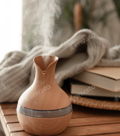 Preview: Aroma oil diffuser lamp on a blurred background in the interior of the room.
