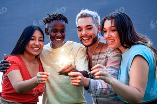 Preview: Diverse group of friends having fun celebrating with sparklers - Focus on Asian girl face