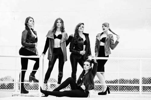 Preview: Group of sexy models girls in black bra and leather jackets on the dock